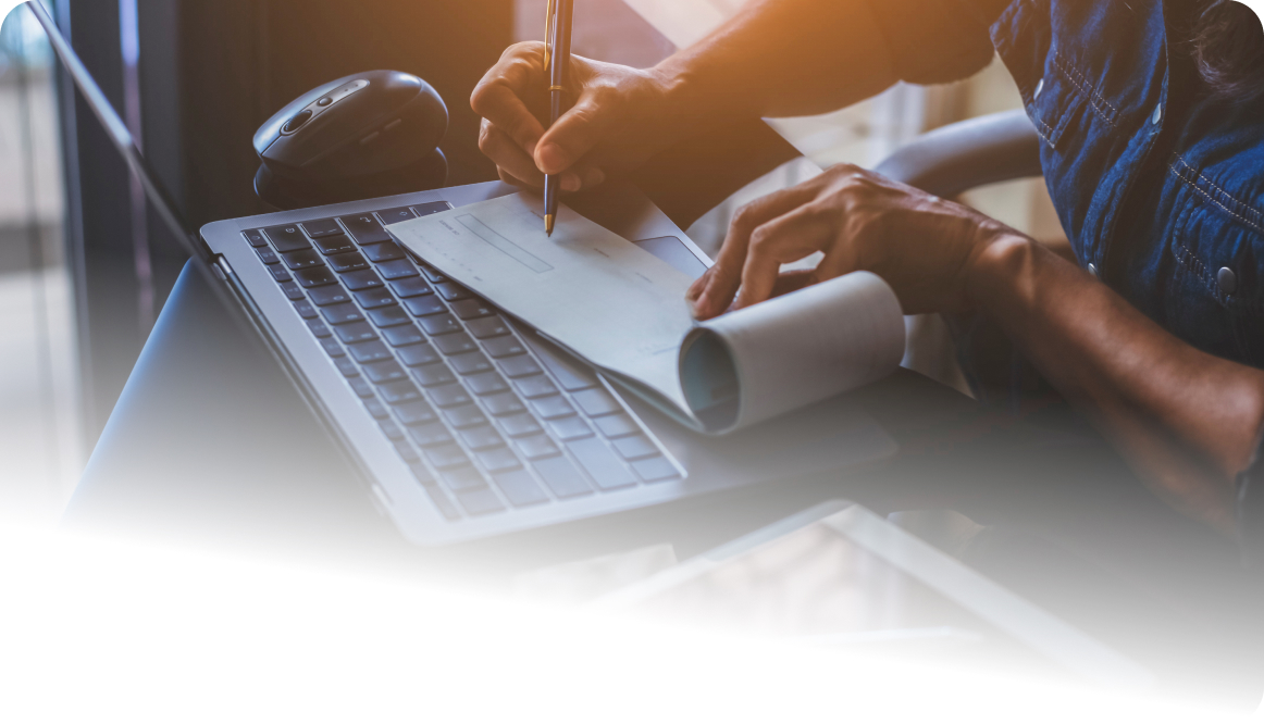 Woman at laptop writing a check