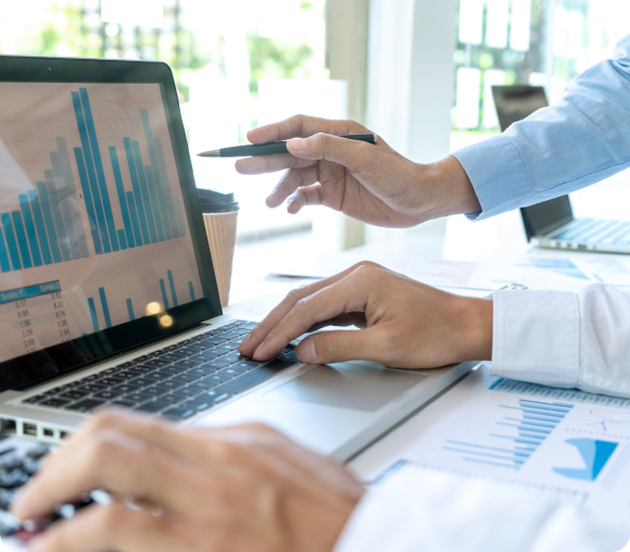 Pointing to graph on laptop
